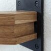 7033-F satin black flat rosette with a wood handrail mounted to the wall