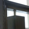 Round bar stem handrail bracket on a horizontal bar stair railing