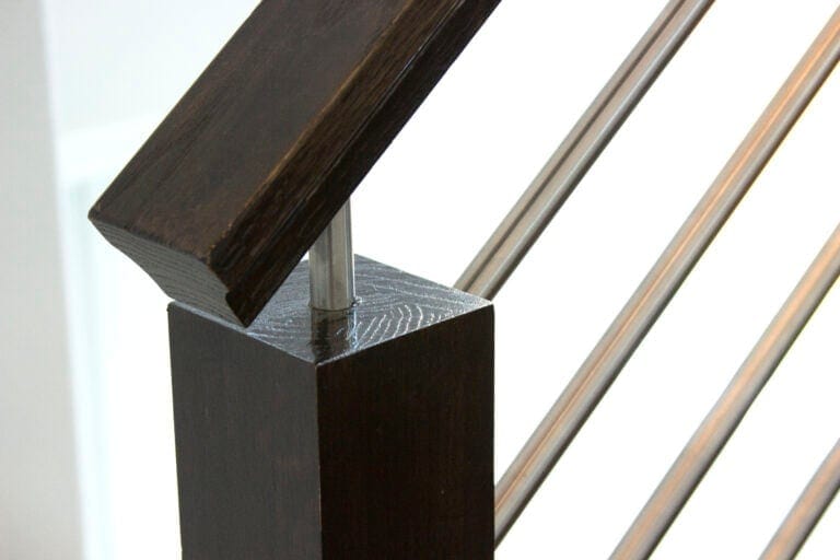 Round bar stem handrail bracket holding horizontal bar railing