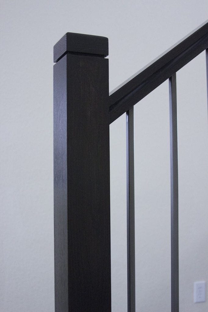 MG_7820.jpg Black newel posts with square wood newel caps on a staircase