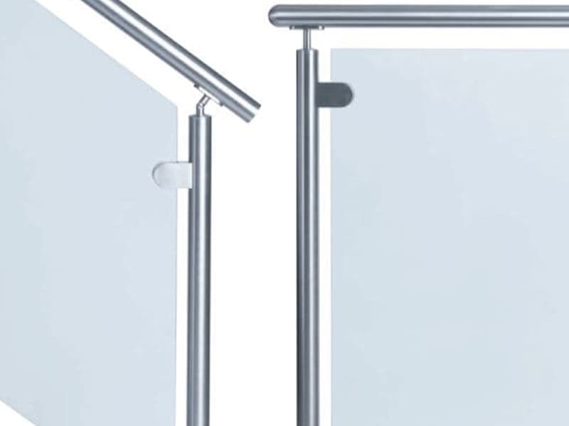 Round stainless steel posts and handrail with glass clamps holding glass railing panels