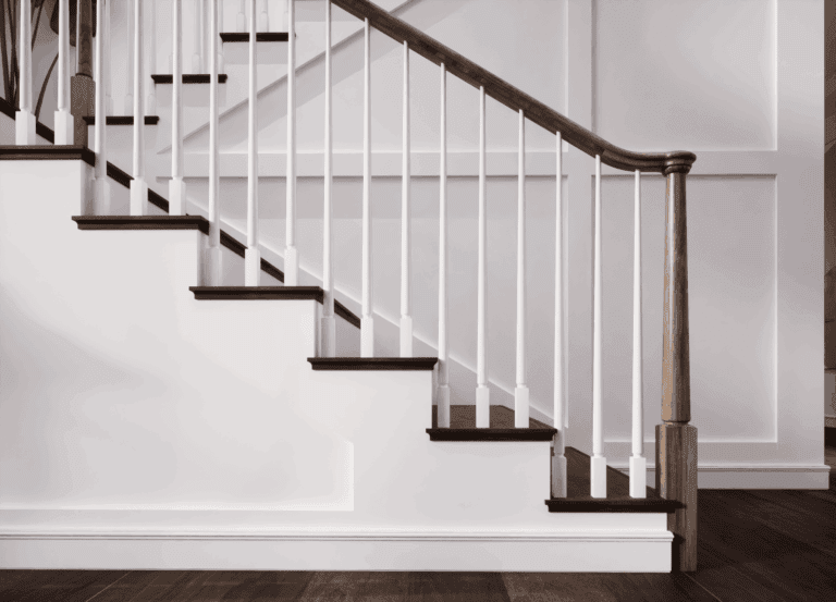 Staircase with Röhe square wood balusters and a dark handrail