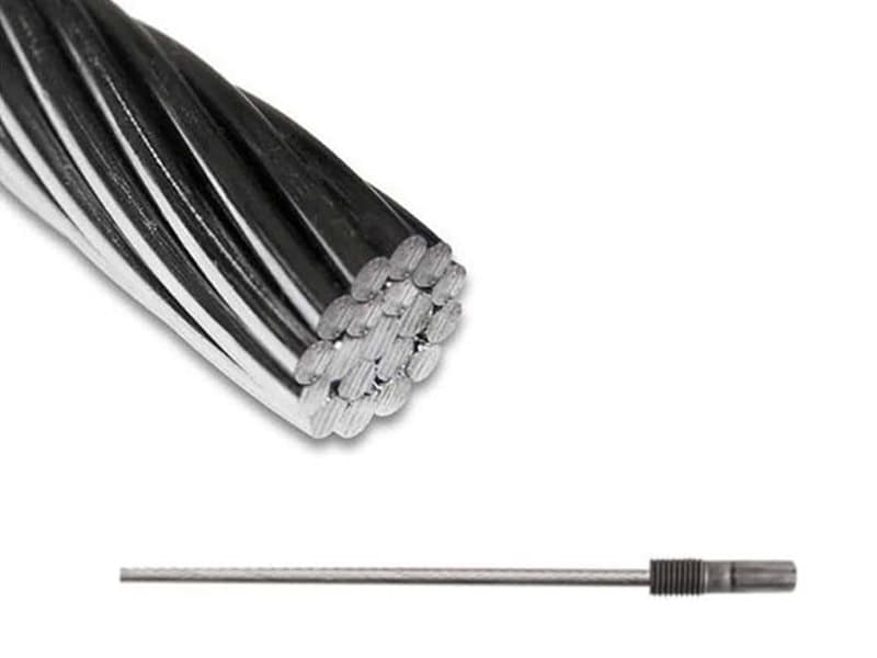 Stainless steel cable with a swaged fitting entering a brushed stainless steel railing post