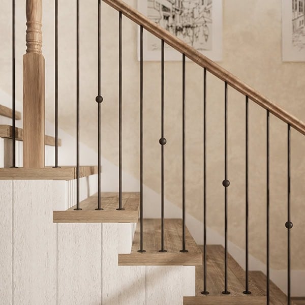 Designer Round iron balusters with single sphere accents on a wood staircase