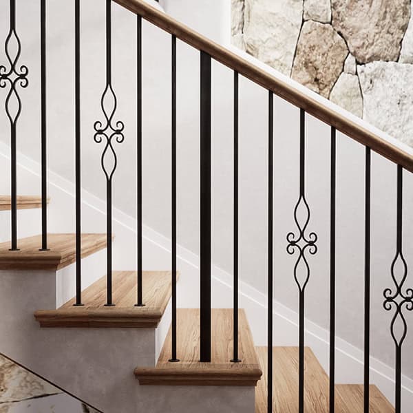 Designer Square iron balusters with scroll accents against a stone wall