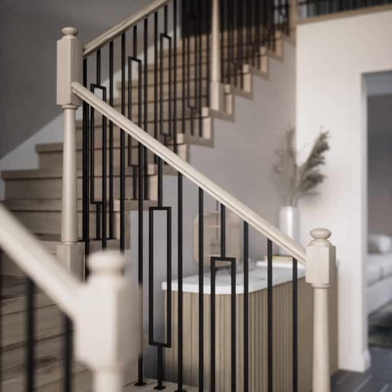 Staircase with Röhe post to post newel posts and iron balusters