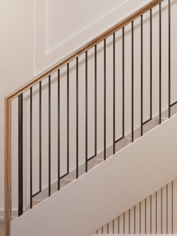 Linéa iron balusters with open asymmetric panels under a wood handrail