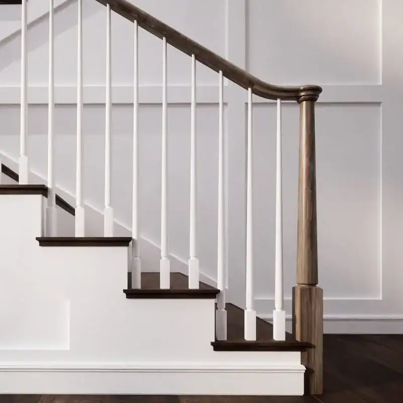 Röhe turned newel post and walnut-stained handrail with white tapered balusters on a staircase with dark wood treads