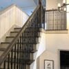 Staircase with 3.2.2 Wentworth triple knuckle hammered iron balusters