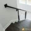 Wood handrail ending at a 7039 square rosette on the wall