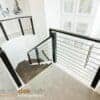 Staircase with 1/2 in round horizontal bar iron balusters