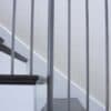Staircase with 48-60 in retrofit return tread kit with riser, red oak