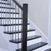 Staircase with 48-60 in retrofit return tread kit with riser, red oak