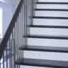 Staircase with 42-60 in retrofit tread kit with riser, red oak
