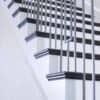 Staircase with 48-60 in retrofit return tread kit with riser, red oak