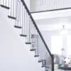 Staircase with 48-60 in retrofit return tread kit with riser, red oak