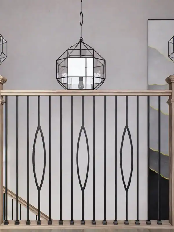 Black iron balusters with single ellipse accents and a light oak handrail on a balcony railing