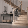Röhe post to post newel post at the bottom of a staircase with iron balusters