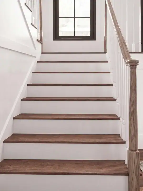 Oak stair treads with white risers on a remodeled staircase