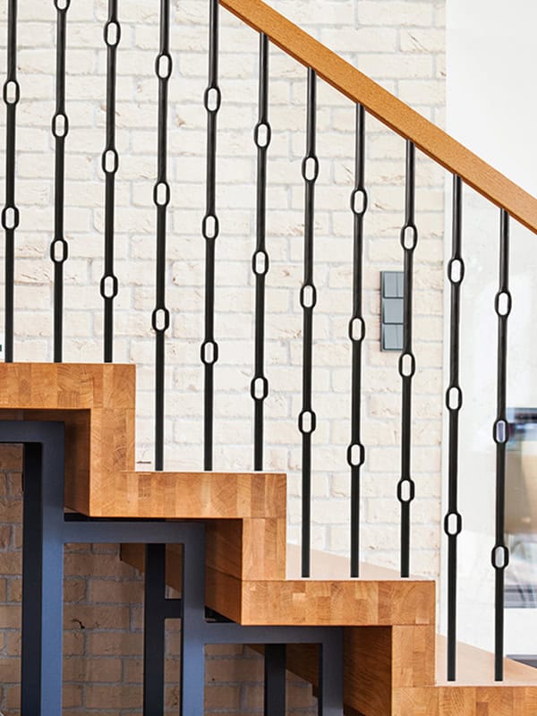 Wentworth black iron balusters with oval links on oak block stairs